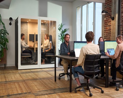 Group of people working in office environment sitting down